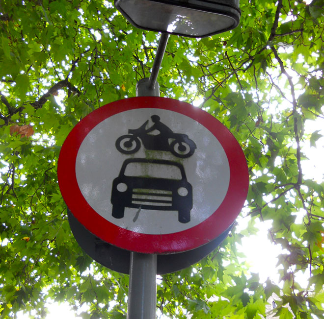 Funny Sign: Motorcycle Jumping Over Car