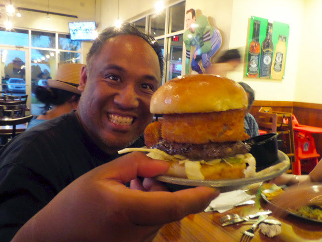 Our friend was really happy when his big burger got to the table. Look at that onion ring! | Photo by FamilyVacationHub