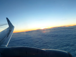 Airplane View Above the Clouds at Sunset